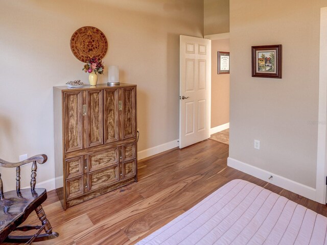 bedroom with hardwood / wood-style flooring