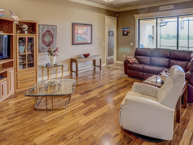 living room featuring hardwood / wood-style flooring and crown molding