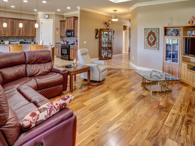 living room with light hardwood / wood-style floors and ornamental molding