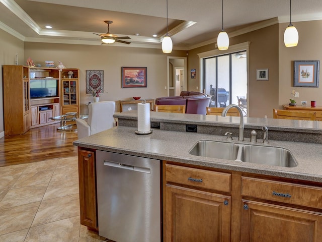 kitchen with pendant lighting, crown molding, sink, stainless steel dishwasher, and light wood-type flooring