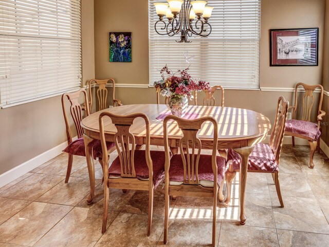 tiled dining space featuring an inviting chandelier