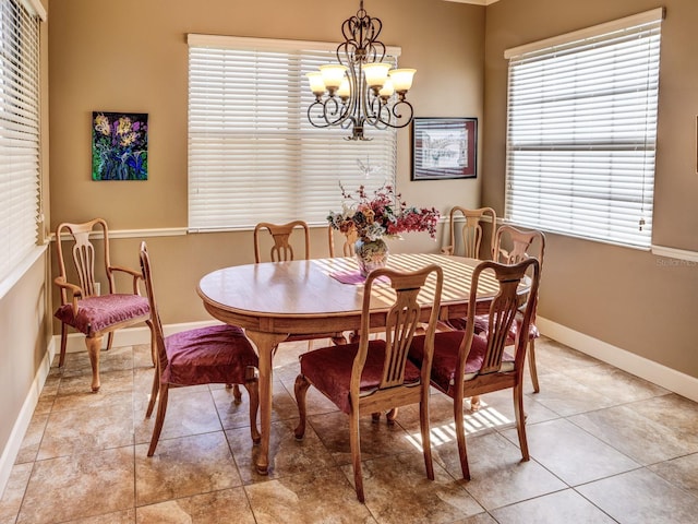 dining room featuring light tile patterned floors and an inviting chandelier