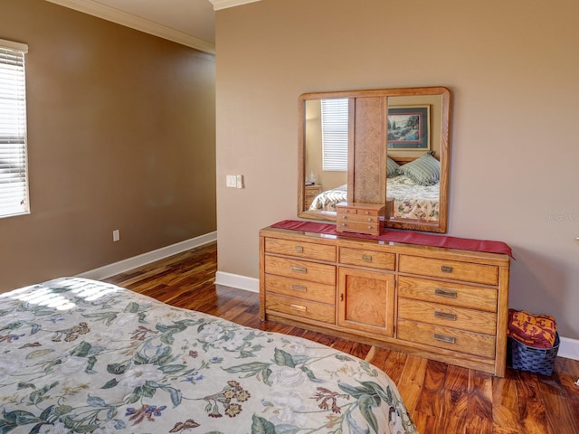 bedroom with crown molding and dark wood-type flooring