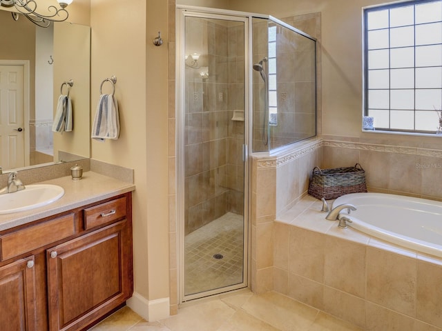 bathroom featuring tile patterned floors, vanity, independent shower and bath, and a wealth of natural light