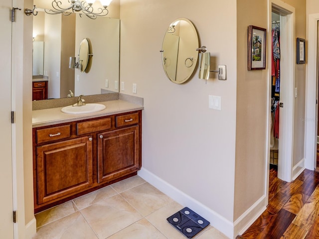 bathroom with a chandelier, wood-type flooring, and vanity