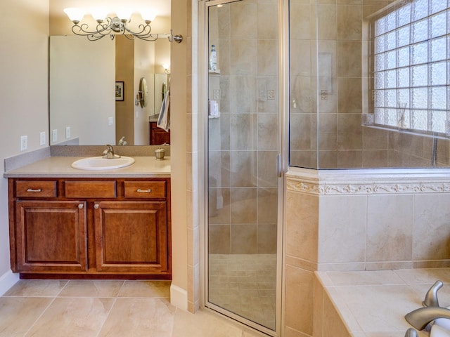 bathroom featuring tile patterned flooring, vanity, an enclosed shower, and a notable chandelier