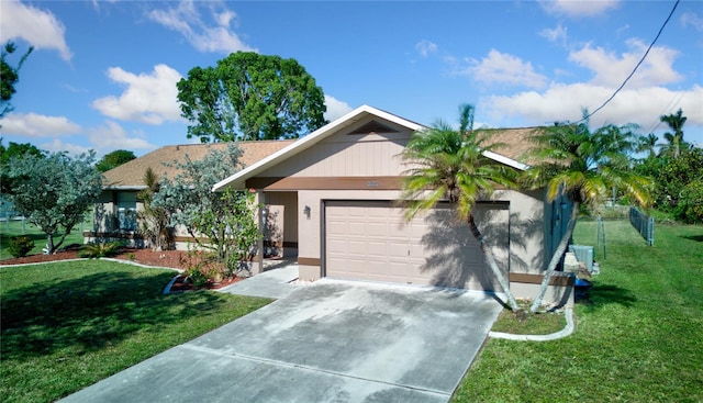 ranch-style home featuring a front lawn and a garage