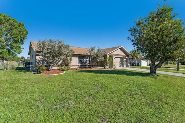 view of front of home featuring a garage and a front lawn