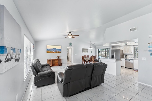 living room featuring ceiling fan, light tile patterned flooring, and vaulted ceiling