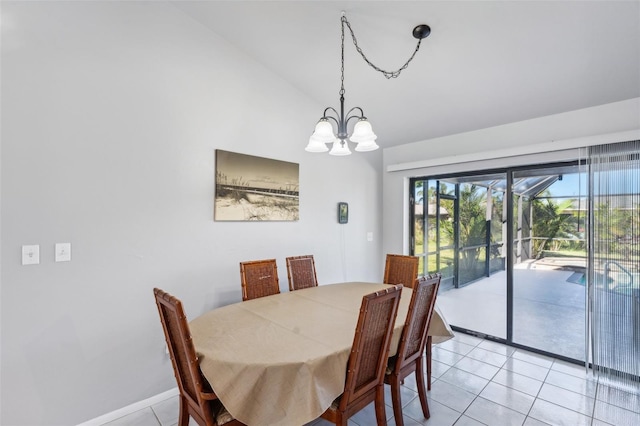 tiled dining area featuring a notable chandelier and lofted ceiling