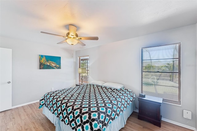 bedroom with ceiling fan and light hardwood / wood-style floors