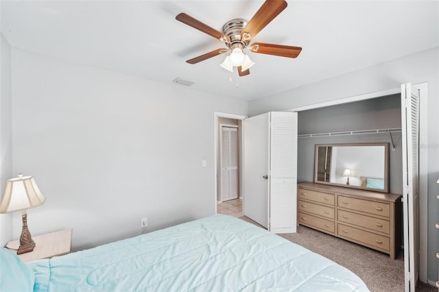 bedroom with ceiling fan, a closet, and light carpet