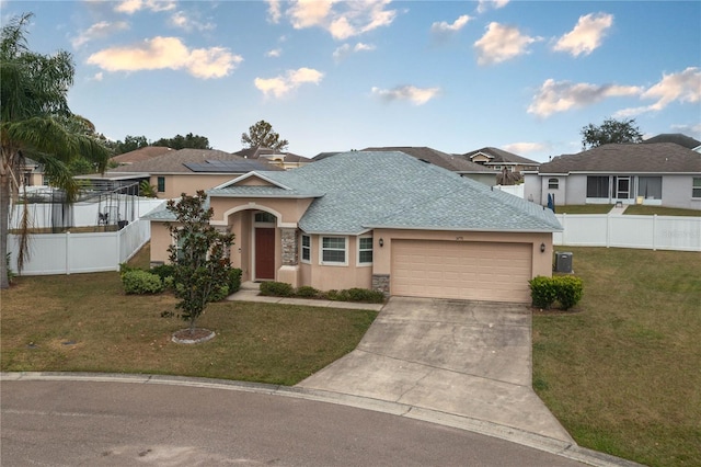 view of front of house featuring central AC, a front lawn, and a garage