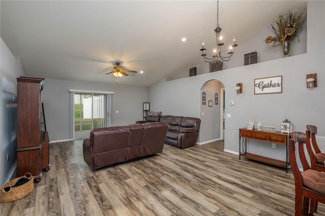 living room with hardwood / wood-style floors, ceiling fan with notable chandelier, and lofted ceiling