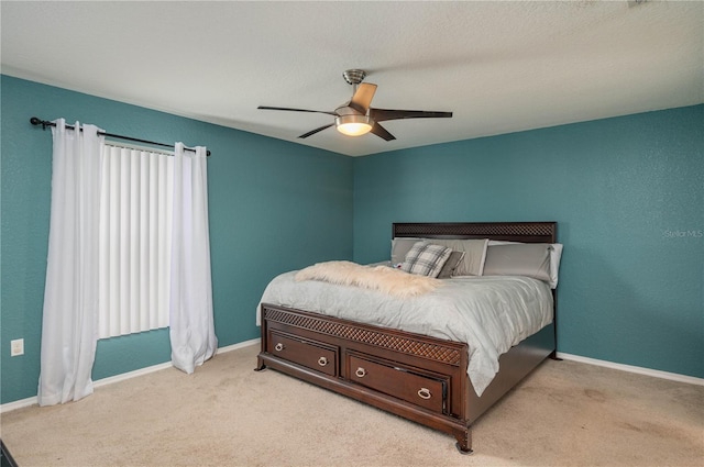 bedroom with ceiling fan and light colored carpet