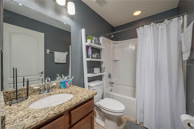 full bathroom with vanity, tile patterned floors, shower / bath combination with curtain, toilet, and a textured ceiling