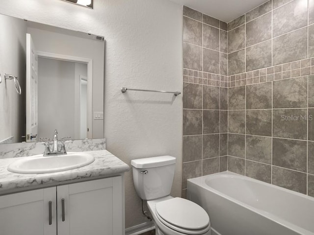 full bathroom with vanity, tiled shower / bath combo, and toilet