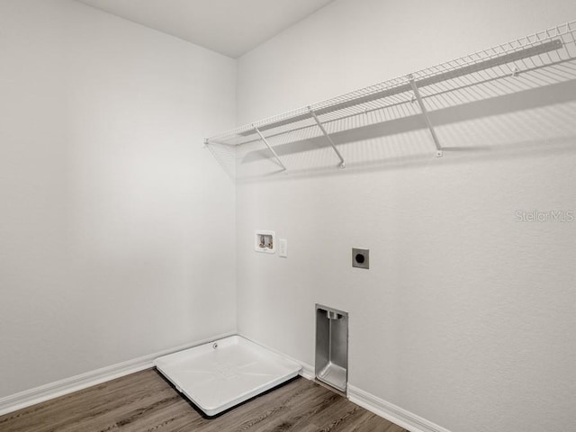 clothes washing area featuring electric dryer hookup, hardwood / wood-style floors, and washer hookup