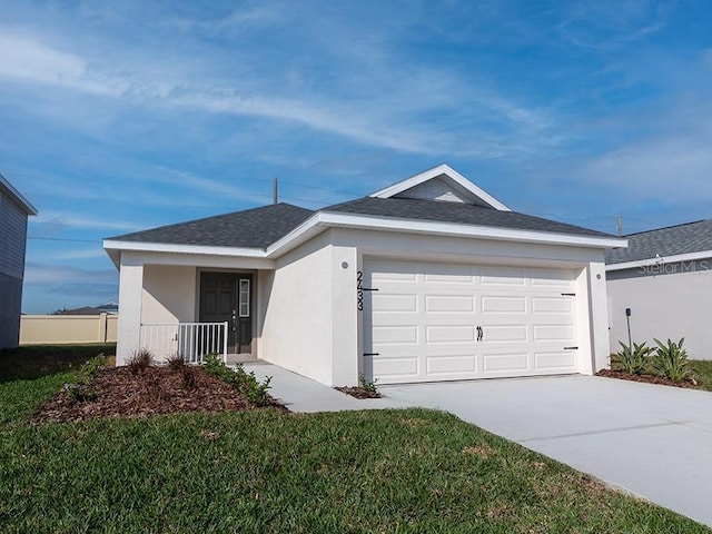 ranch-style house with a garage and a front lawn