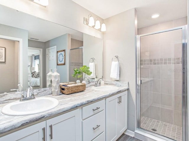 bathroom featuring hardwood / wood-style floors, vanity, and walk in shower