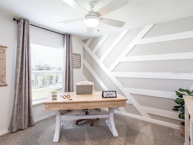 carpeted office space featuring ceiling fan