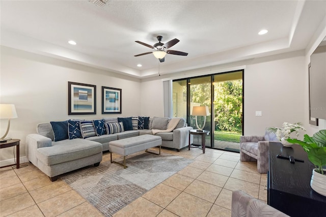 living room with ceiling fan and light tile patterned flooring