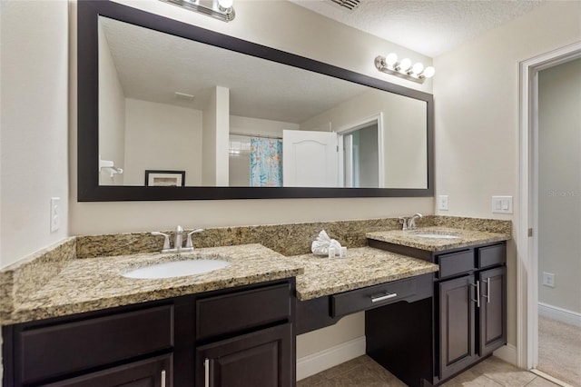 bathroom featuring tile patterned flooring, vanity, a textured ceiling, and a shower with shower curtain