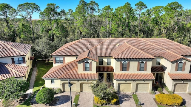 mediterranean / spanish-style house with a garage