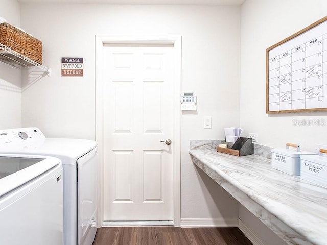 laundry area with dark hardwood / wood-style flooring and washer and dryer