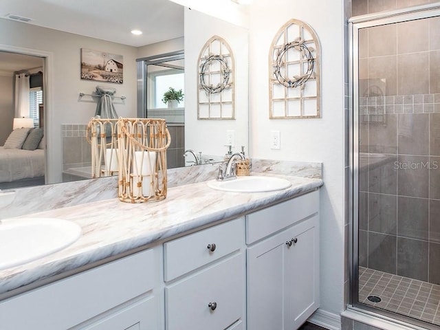 bathroom featuring vanity and an enclosed shower