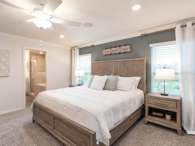 carpeted bedroom with ensuite bathroom, ceiling fan, and ornamental molding