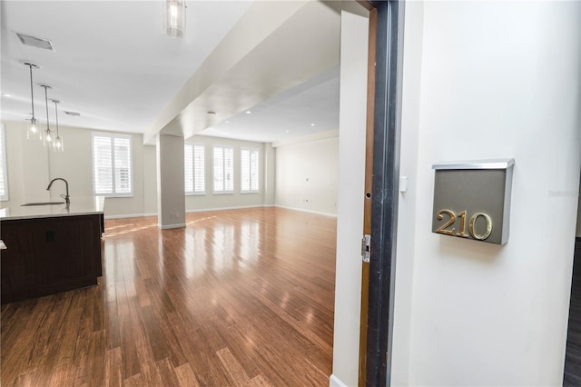 living room with wood-type flooring and sink