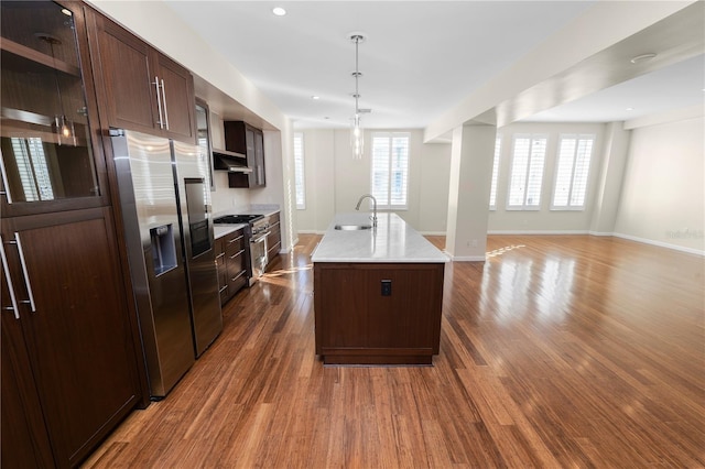 405 Central Ave Unit 210, Saint Petersburg, FL 33701 - kitchen featuring a sink, stainless steel appliances, dark wood-style flooring, open floor plan, and an island with sink