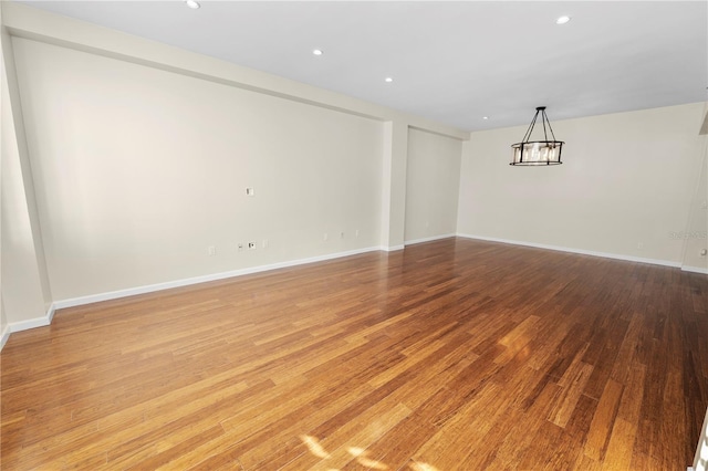 405 Central Ave Unit 210, Saint Petersburg, FL 33701 - empty room with light wood-type flooring, a chandelier, baseboards, and recessed lighting
