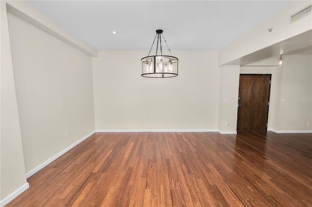 405 Central Ave Unit 210, Saint Petersburg, FL 33701 - spare room featuring a chandelier, wood finished floors, baseboards, and recessed lighting