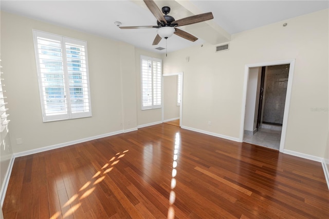 unfurnished room featuring wood-type flooring, ceiling fan, and beam ceiling