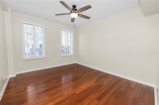 empty room with ceiling fan and dark hardwood / wood-style flooring