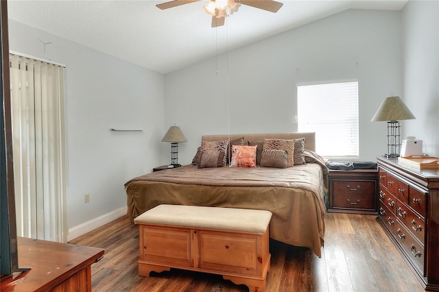 bedroom featuring ceiling fan, dark hardwood / wood-style floors, and lofted ceiling