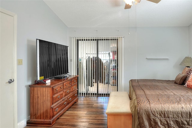 bedroom featuring dark hardwood / wood-style floors, ceiling fan, and a textured ceiling