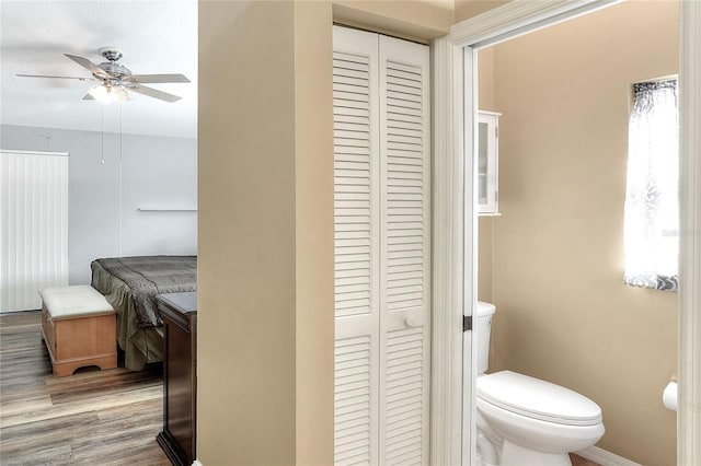 bathroom featuring ceiling fan, toilet, a textured ceiling, and hardwood / wood-style flooring