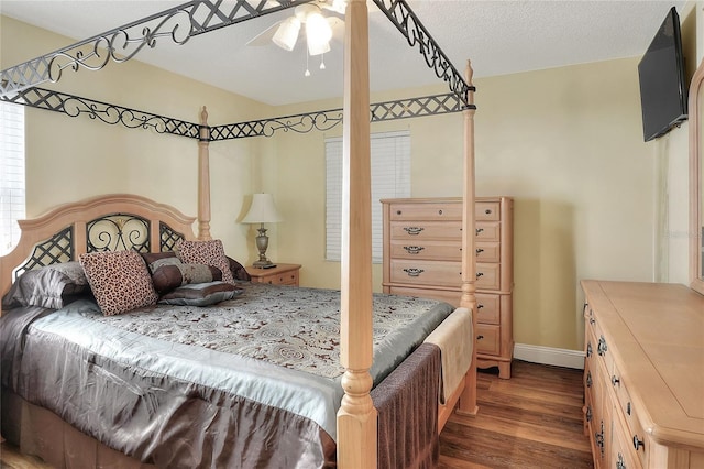 bedroom featuring a textured ceiling, ceiling fan, and dark wood-type flooring