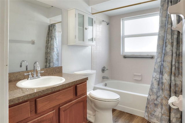 full bathroom with vanity, hardwood / wood-style flooring, toilet, and shower / bath combo with shower curtain