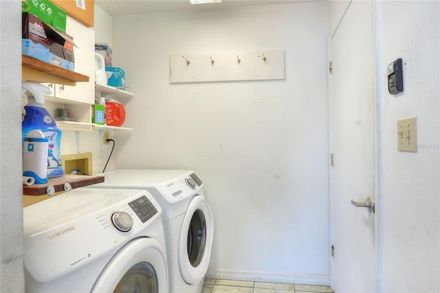 laundry room with independent washer and dryer and light tile patterned floors