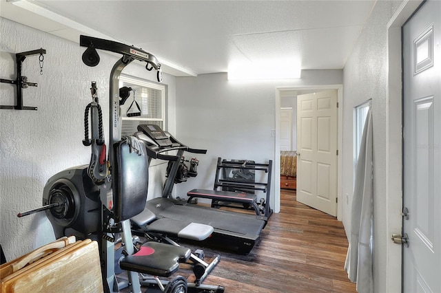 workout area with dark hardwood / wood-style flooring