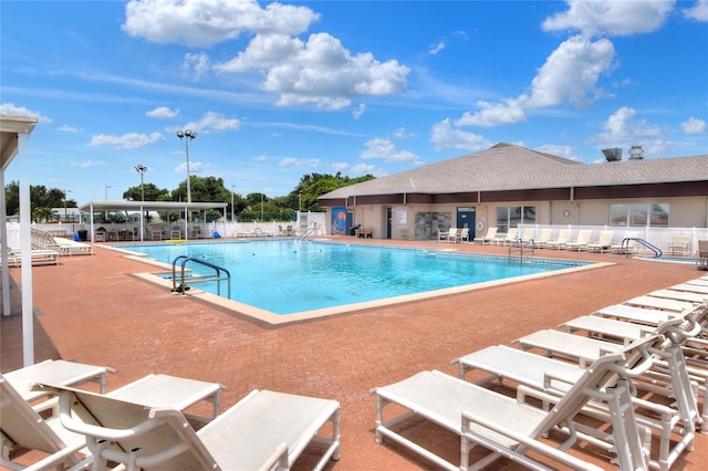 view of swimming pool featuring a patio area