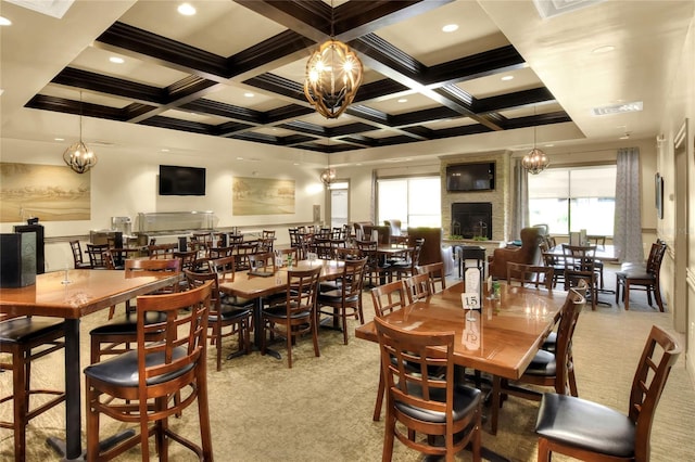 carpeted dining space featuring a fireplace, beam ceiling, coffered ceiling, and a notable chandelier