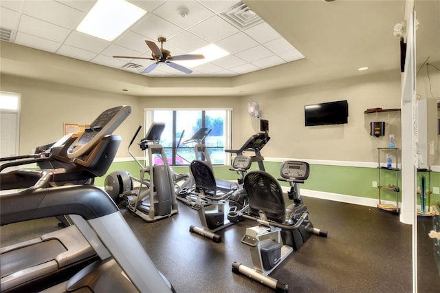 workout area with a drop ceiling and ceiling fan