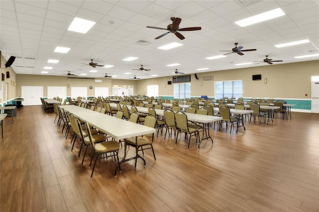 dining room with a paneled ceiling, ceiling fan, and hardwood / wood-style flooring