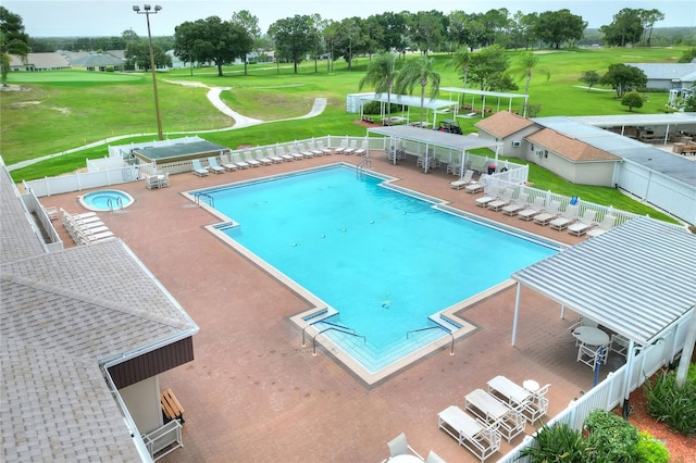 view of swimming pool featuring a community hot tub and a patio