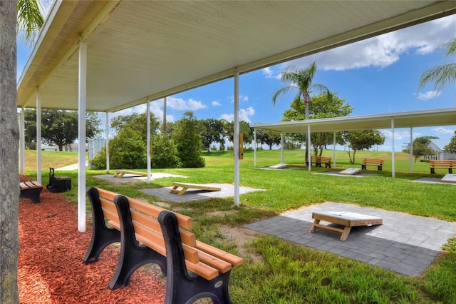 view of property's community with a patio and a lawn